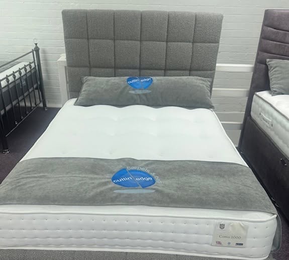 Como 1000 bed with grey boucle headboard and Cuttin Edge branded topper in the Halifax showroom