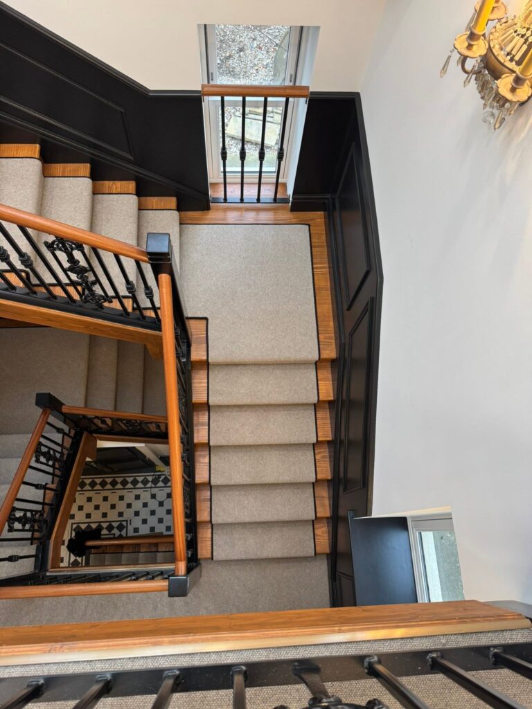 Cream wool stair runner on a galleried oak staircase, fitted by Cuttin Edge Carpets in a Halifax home