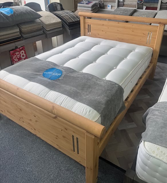 Pine bedstead with quilted mattress and Cuttin Edge branded topper in the Halifax showroom