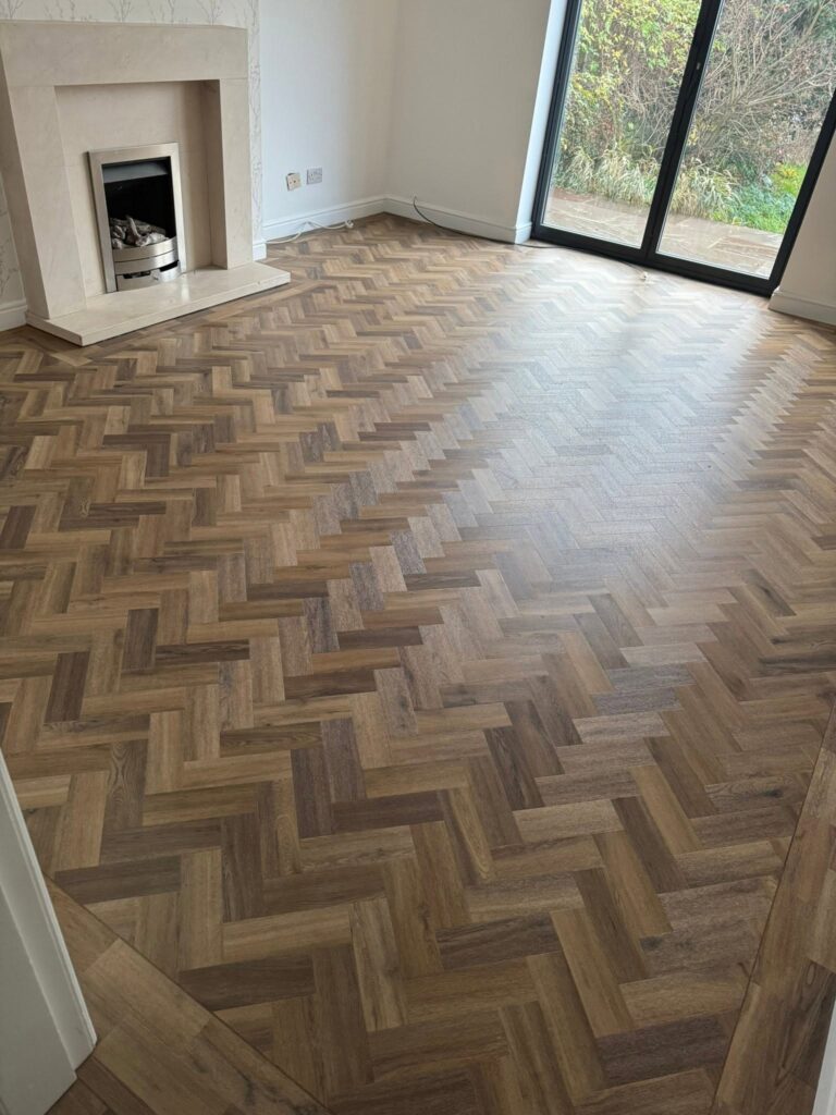 Dark oak herringbone luxury vinyl tile flooring fitted in a bright Halifax living room by Cuttin Edge Carpets